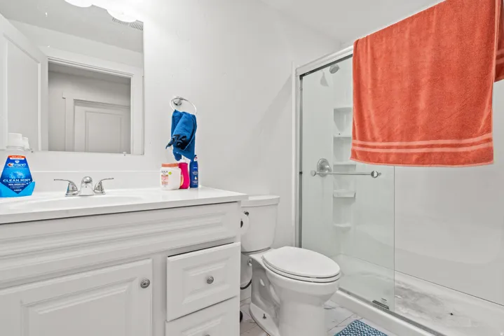 Full bath with vanity and a shower stall