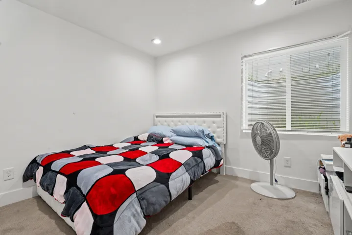 Bedroom featuring light carpet and recessed lighting