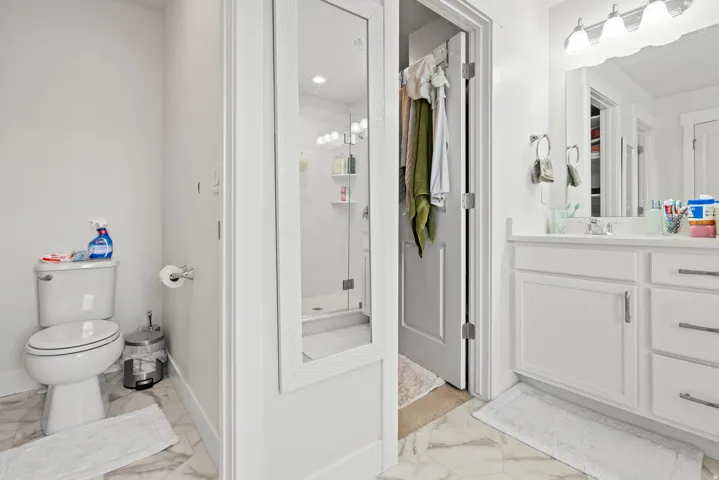 Bathroom with a stall shower, vanity, and light marble finish floors