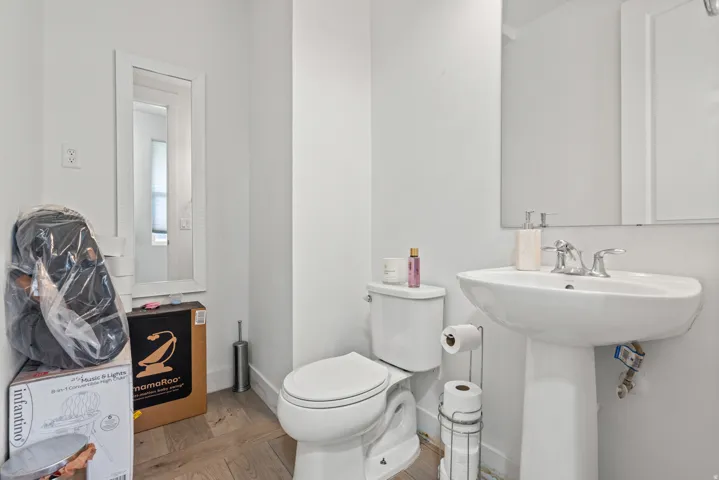 Half bath with light wood finished floors