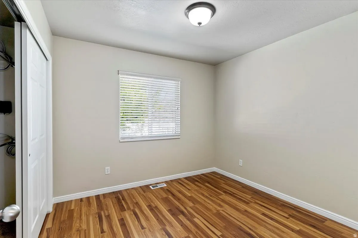 Bedroom with a closet and wood finished floors