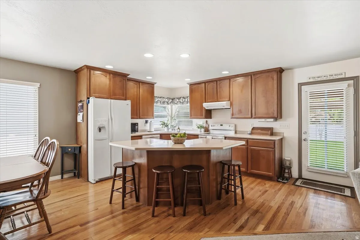 Open kitchen with hardwood flooring