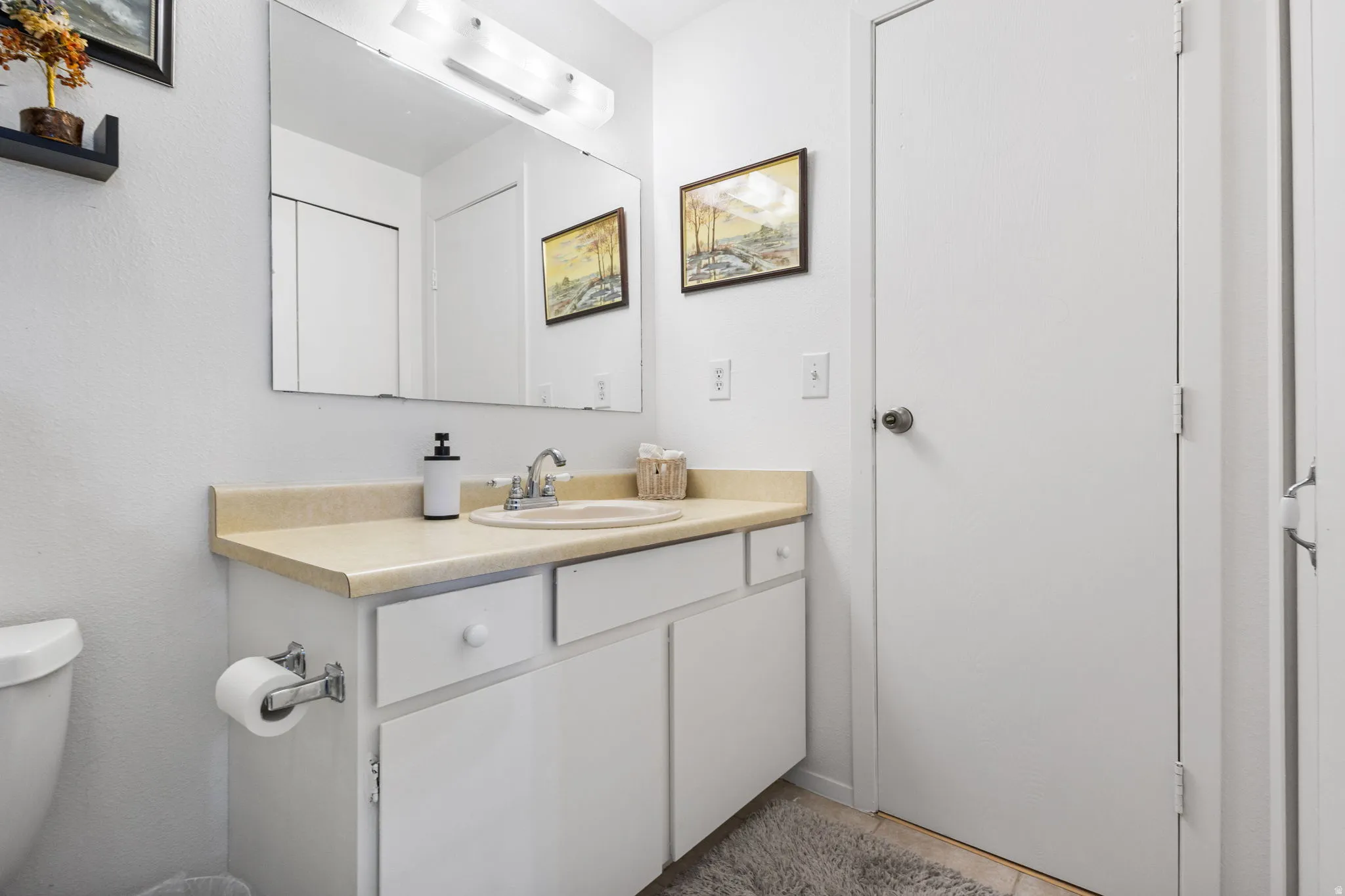 Half bathroom with toilet and vanity