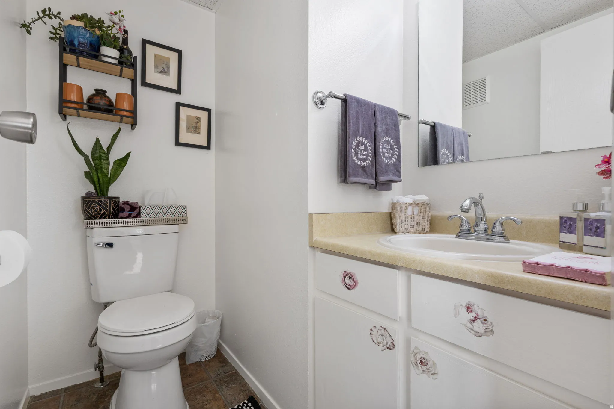 Half bathroom with vanity and toilet