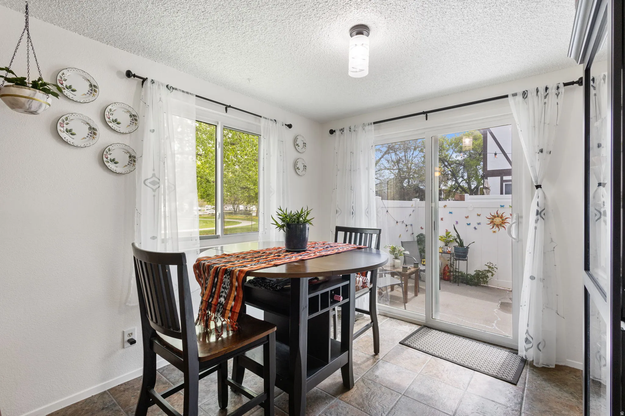 Dining room featuring baseboards and a textured ceiling