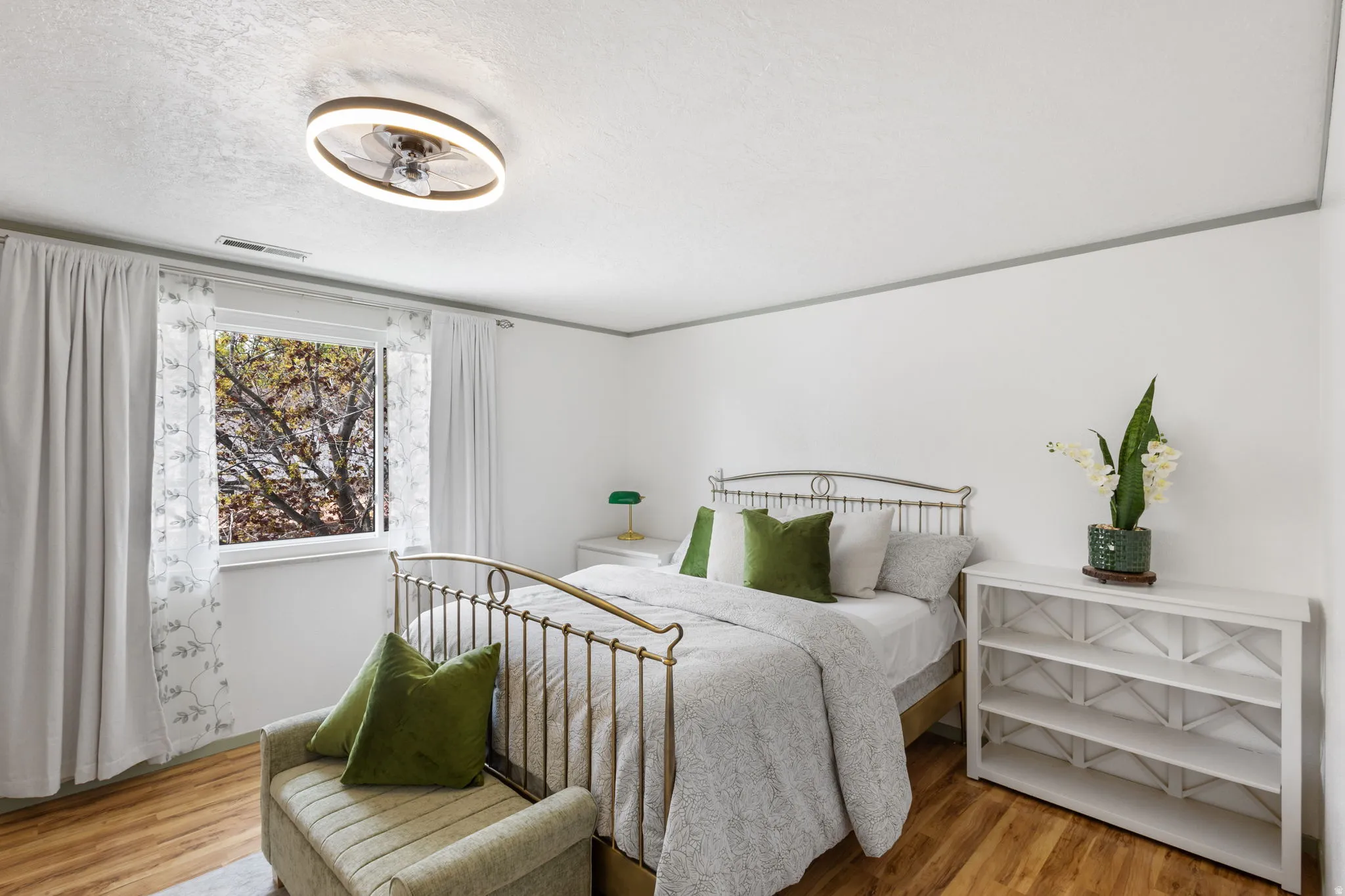 Bedroom featuring light wood-style flooring and a textured ceiling