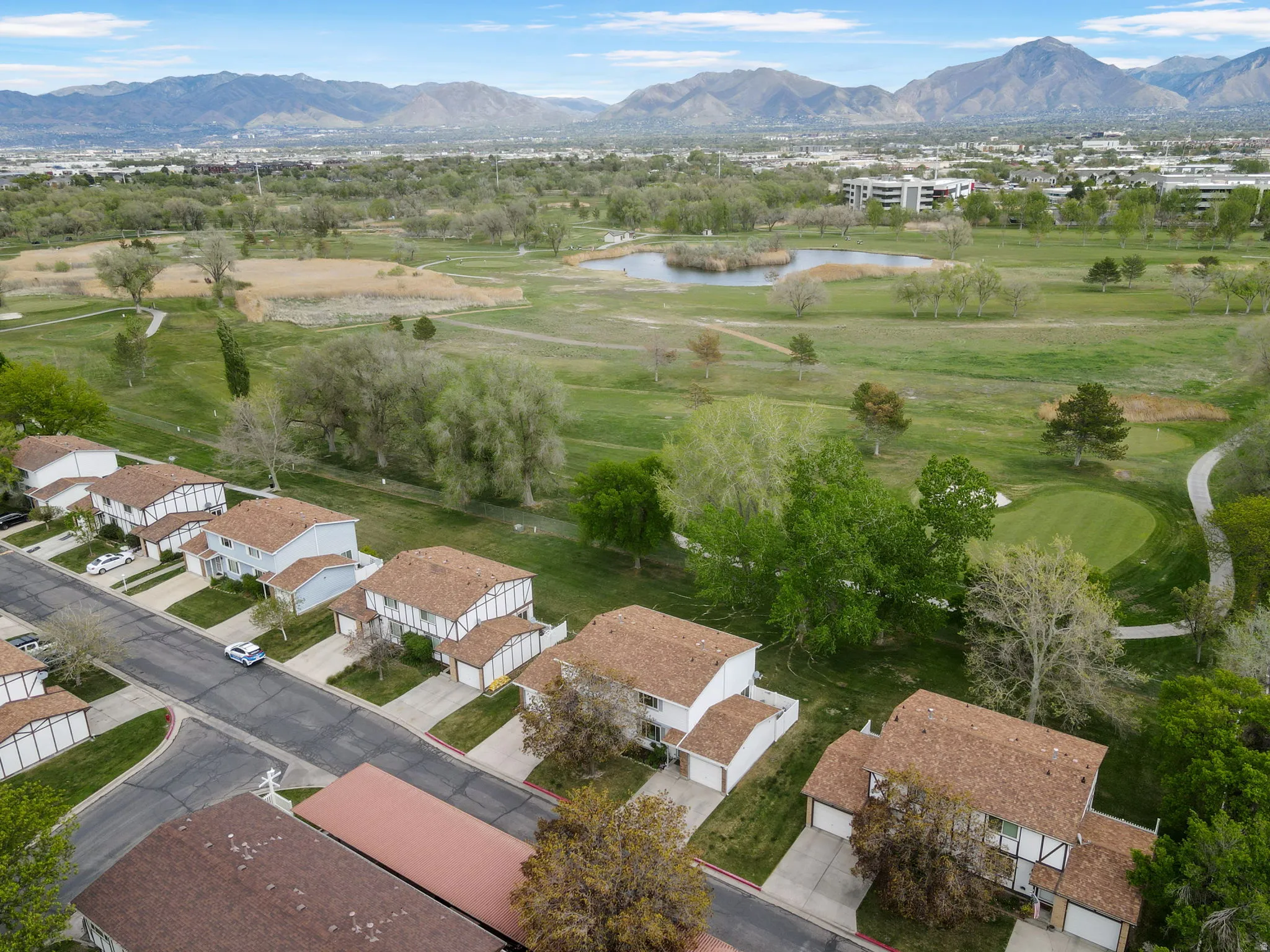 Aerial view of residential area featuring a water and mountain view and a golf club