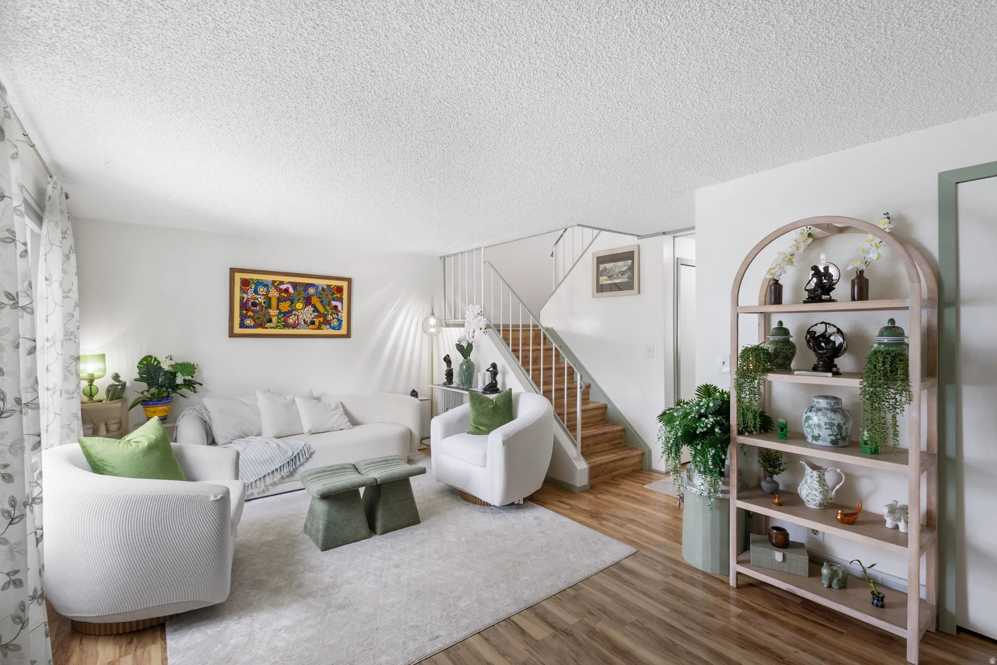 Living area featuring wood finished floors and a textured ceiling