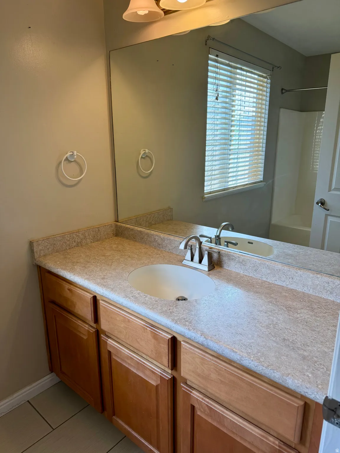 Full bath with vanity, shower / bathtub combination, and light tile patterned floors