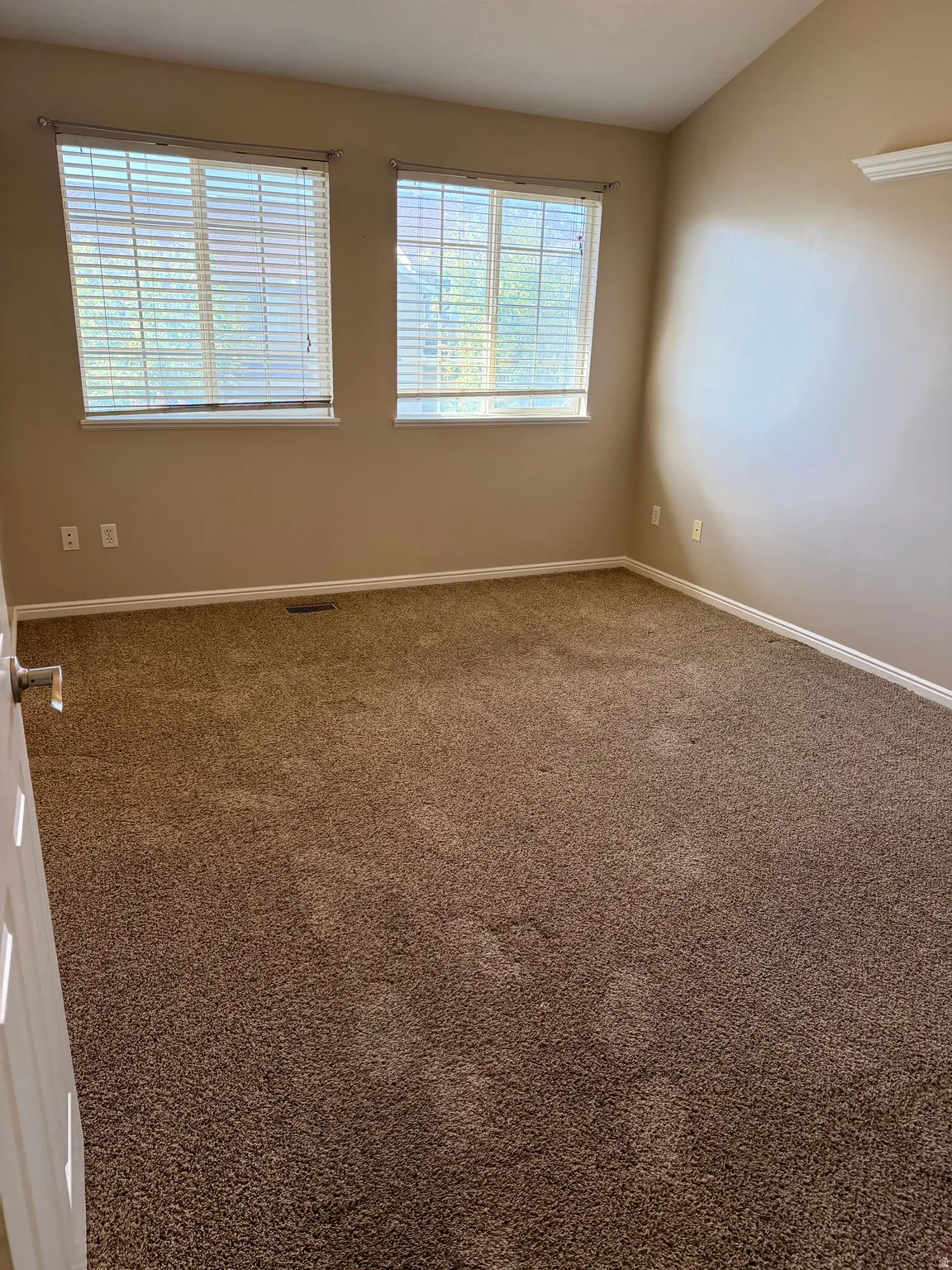 Unfurnished room featuring carpet flooring and vaulted ceiling