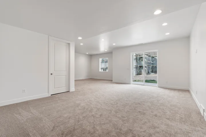 Spare room featuring recessed lighting and light colored carpet