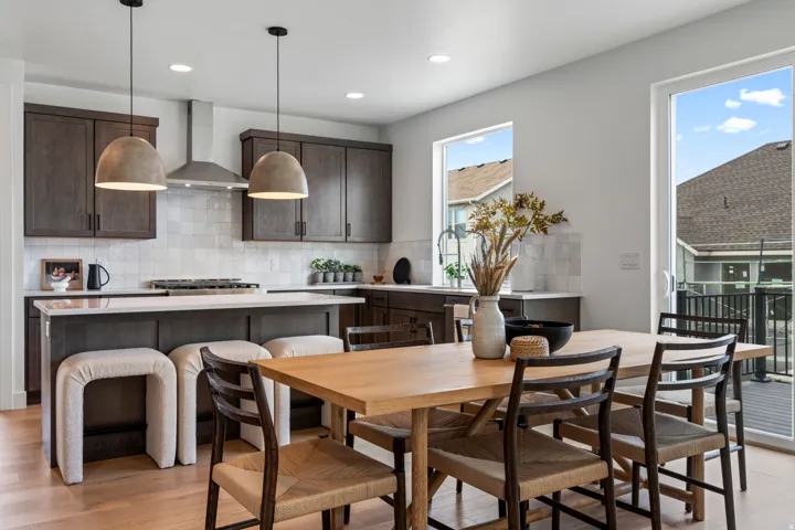 Dining room with light wood-type flooring and recessed lighting
