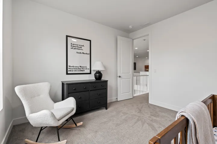 Living area with light colored carpet and baseboards