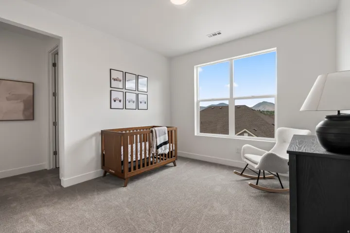 Bedroom with carpet and a nursery area