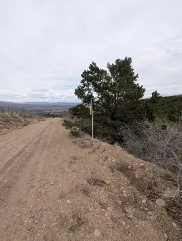View of dirt / gravel road featuring a view of countryside