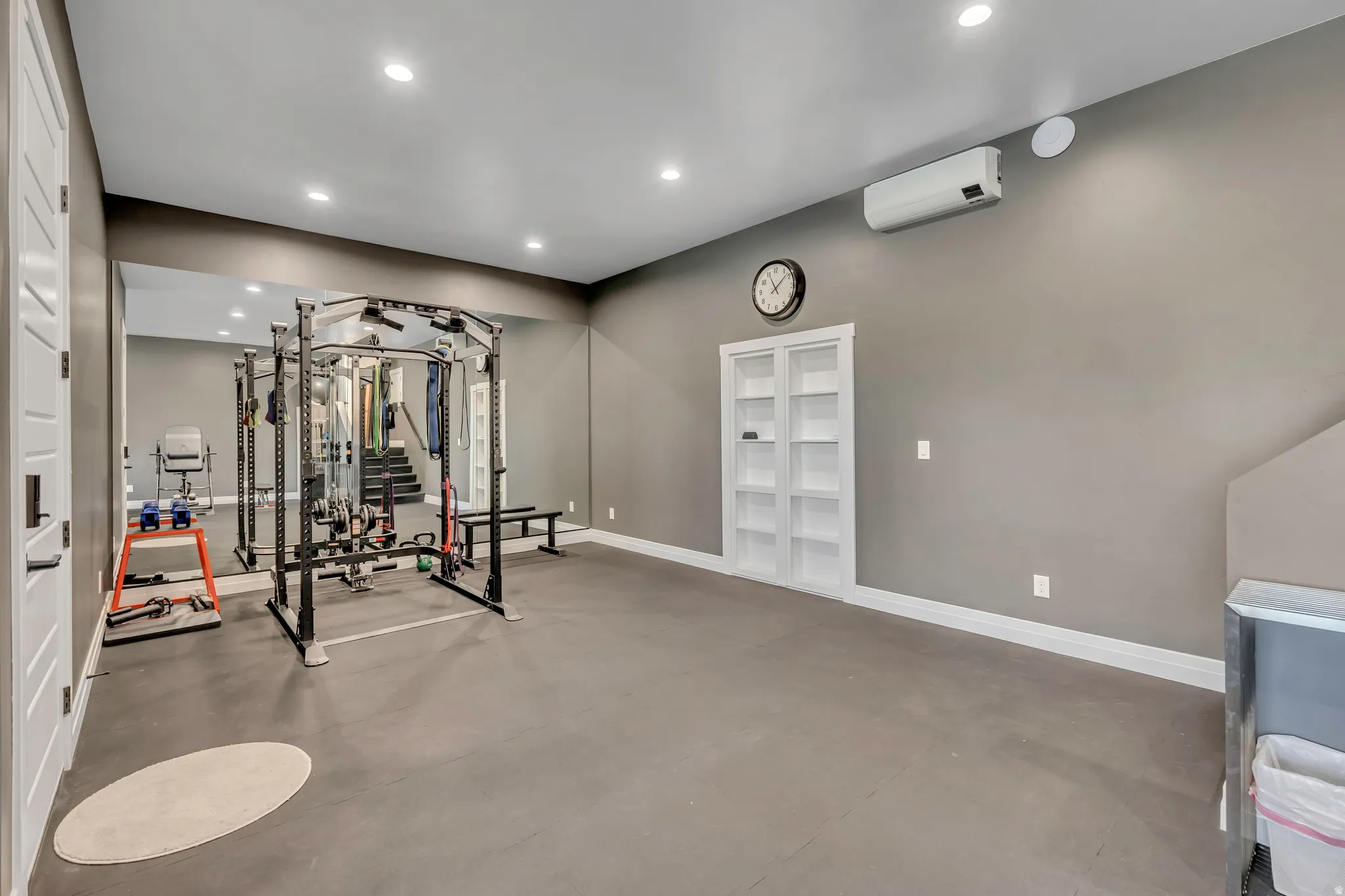Exercise area with recessed lighting and a wall mounted mini split