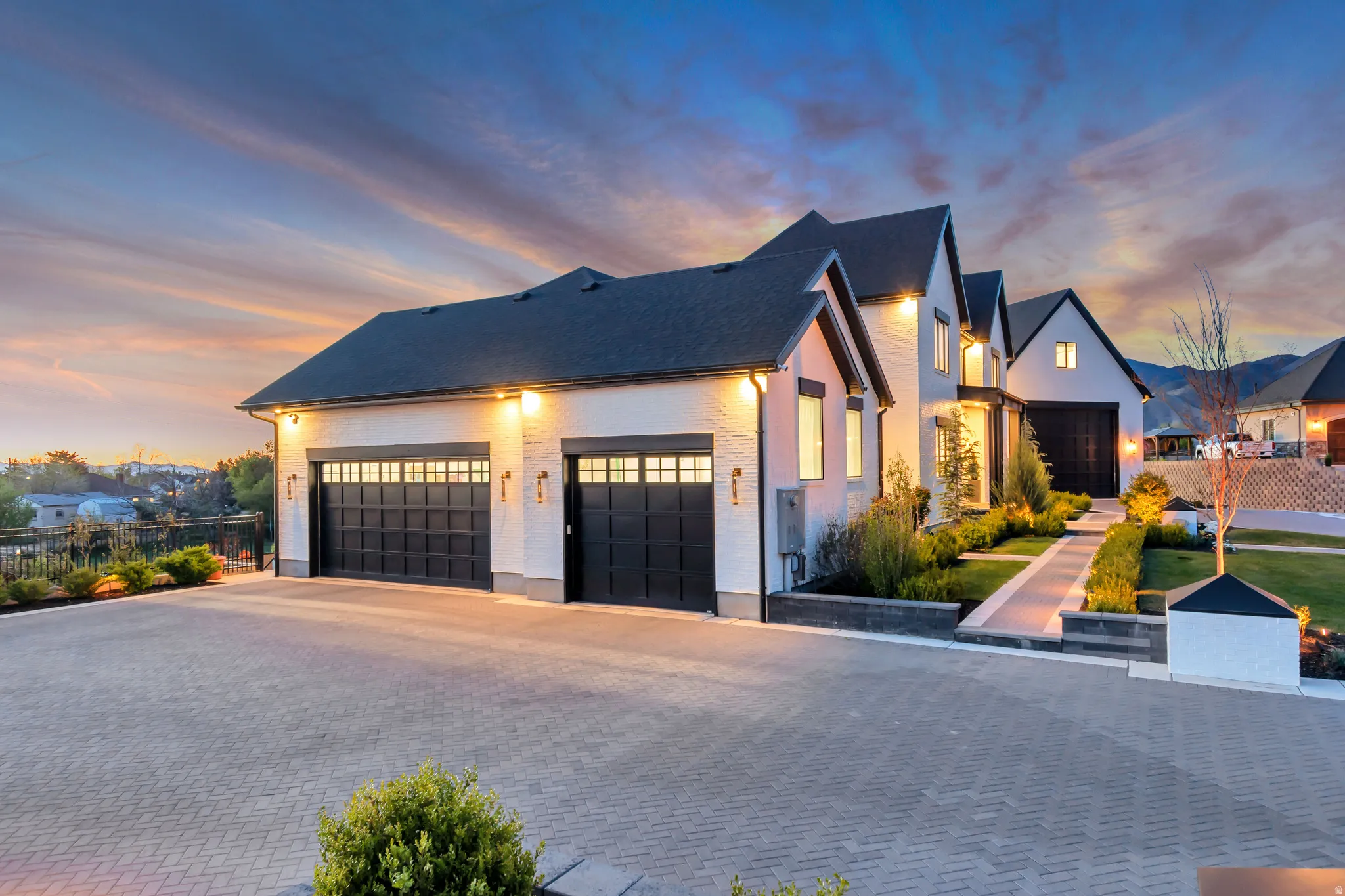 View of front of home featuring decorative driveway, a garage, and brick siding