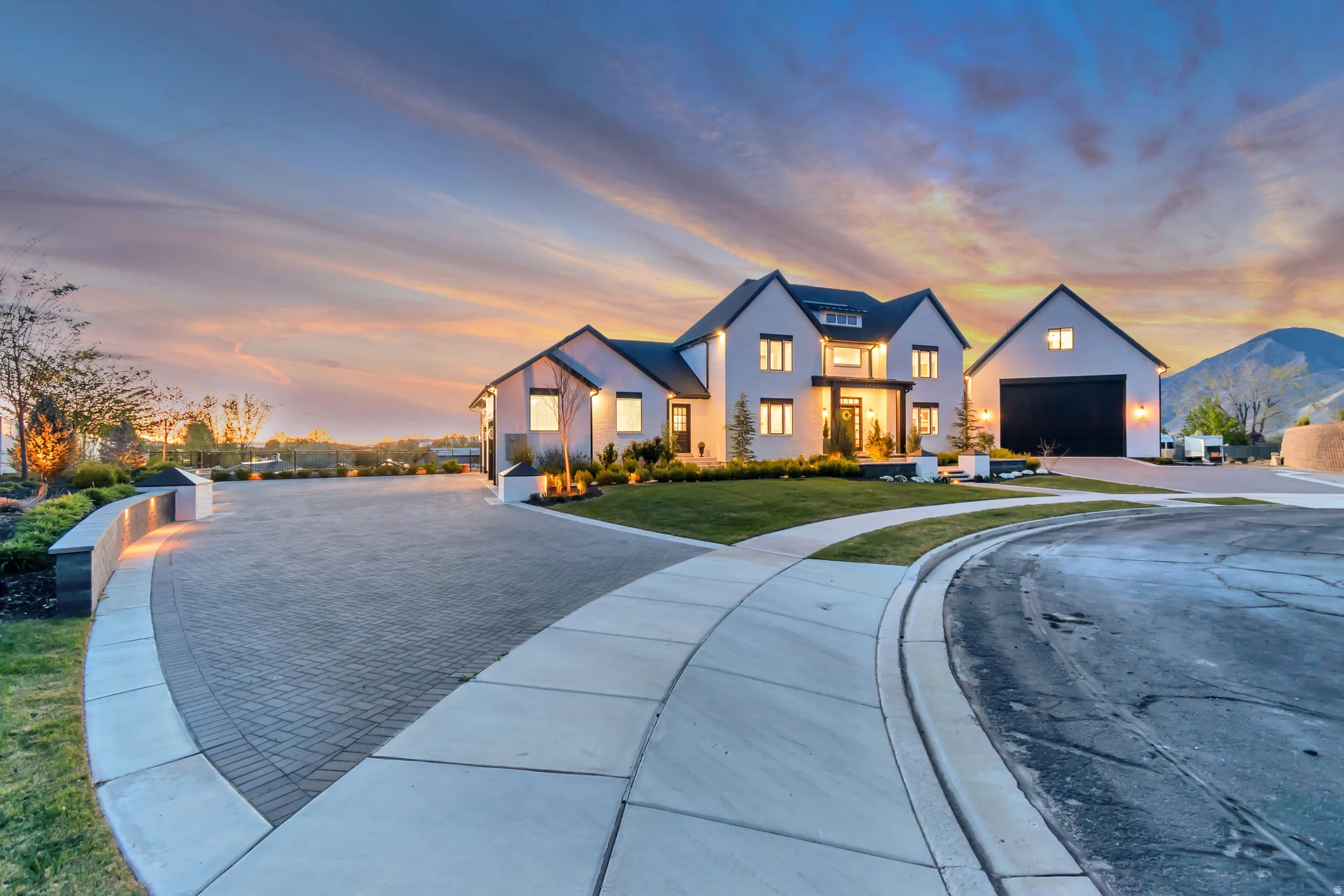 Modern farmhouse with a front lawn, a garage, and driveway