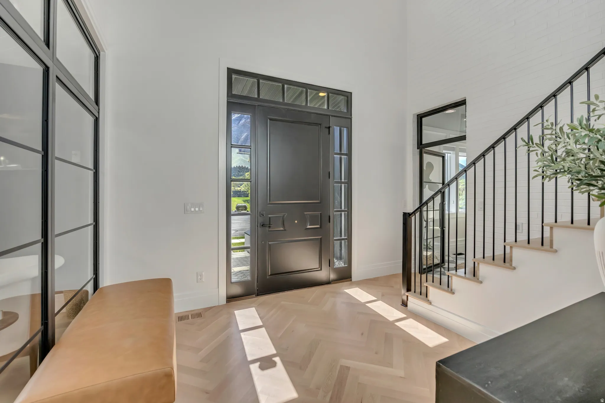Entryway featuring parquet flooring and a high ceiling