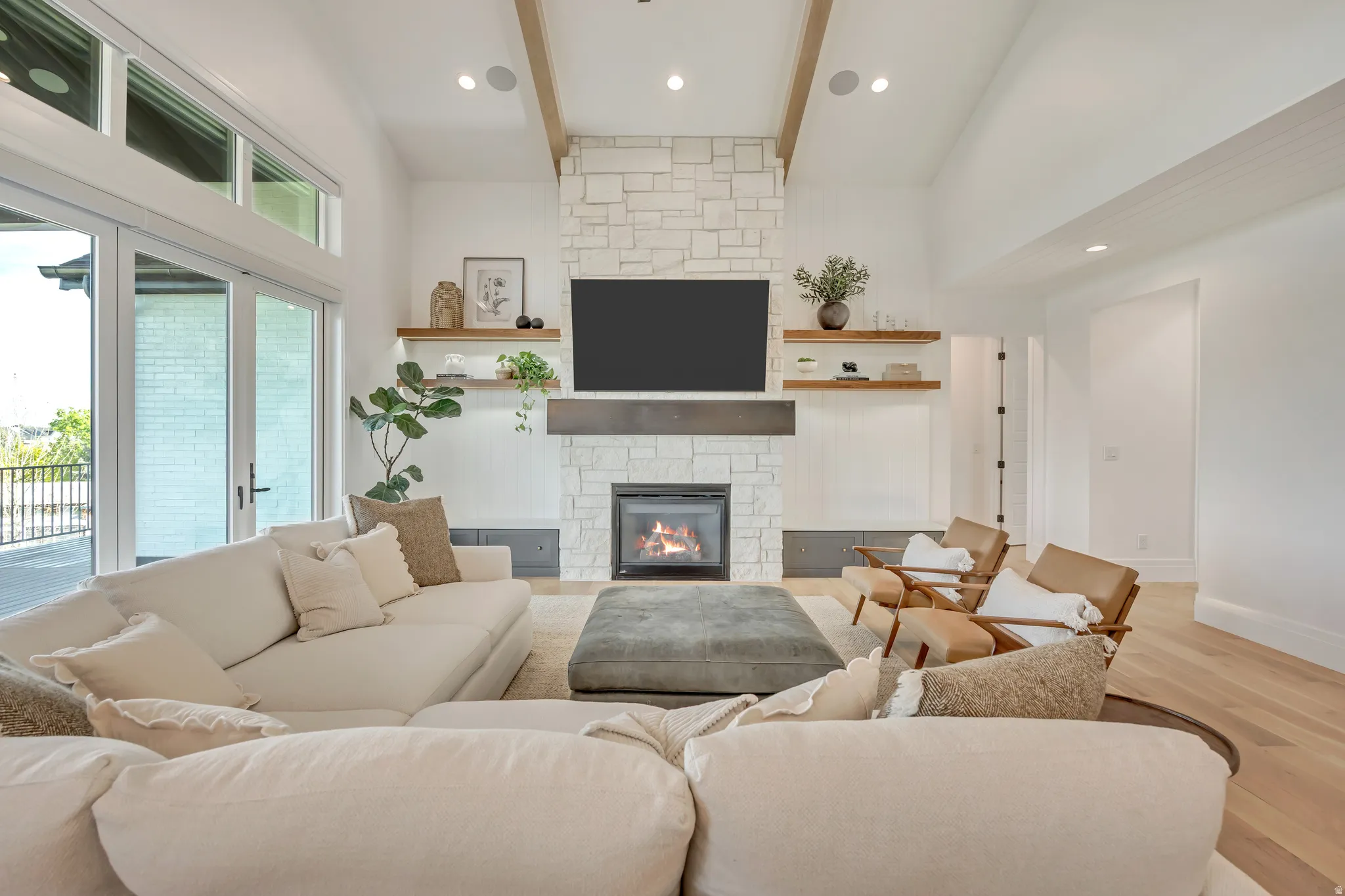 Living area with a fireplace, light wood-style floors, and recessed lighting