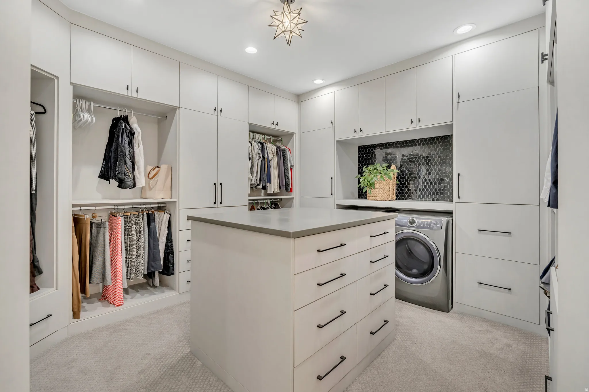 Walk in closet featuring washer / clothes dryer and light colored carpet