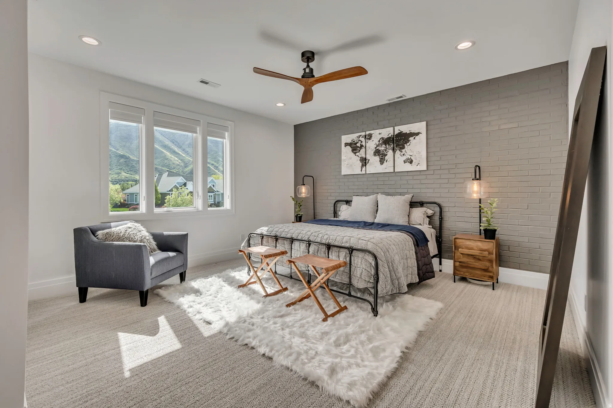 Bedroom featuring brick wall, a ceiling fan, an accent wall, recessed lighting, and light colored carpet