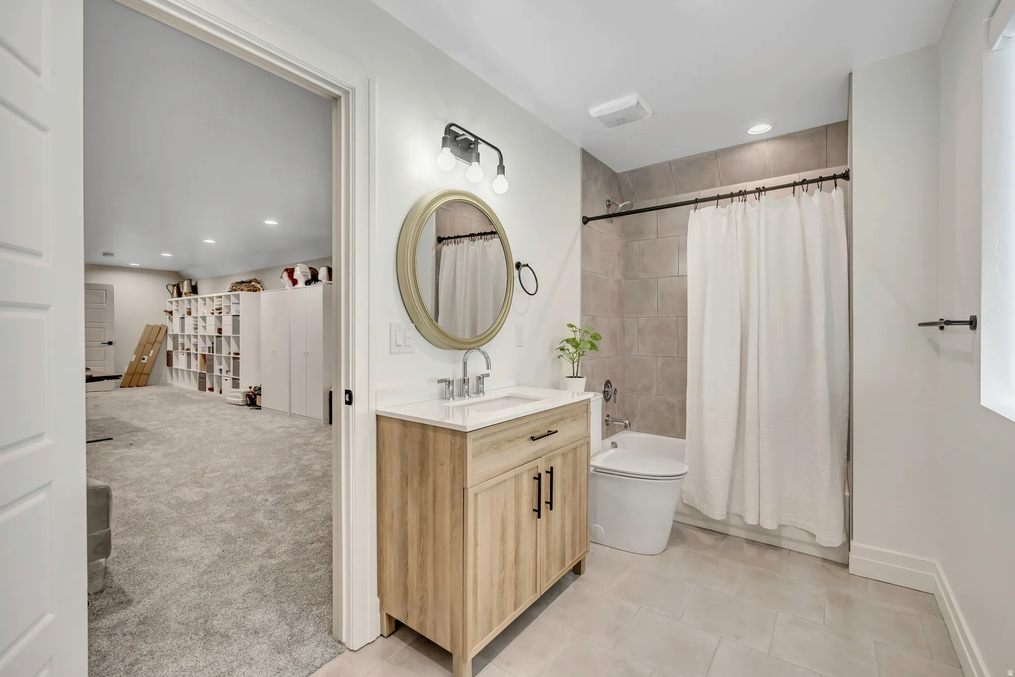 Full bath with vanity, recessed lighting, shower / bathtub combination with curtain, light carpet, and light tile patterned flooring