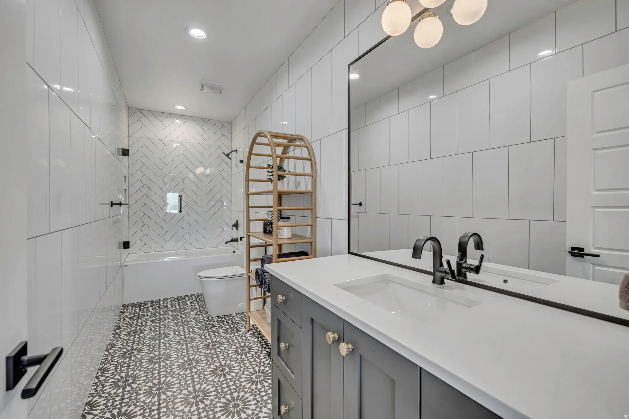 Bathroom with vanity, tile walls, tub / shower combination, recessed lighting, and light tile patterned flooring