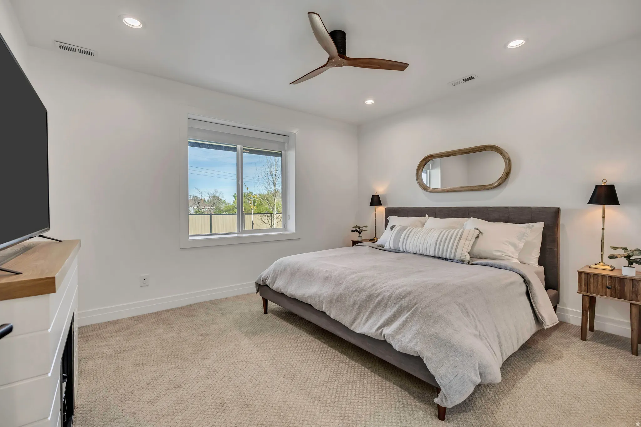 Bedroom with a ceiling fan, recessed lighting, and light colored carpet