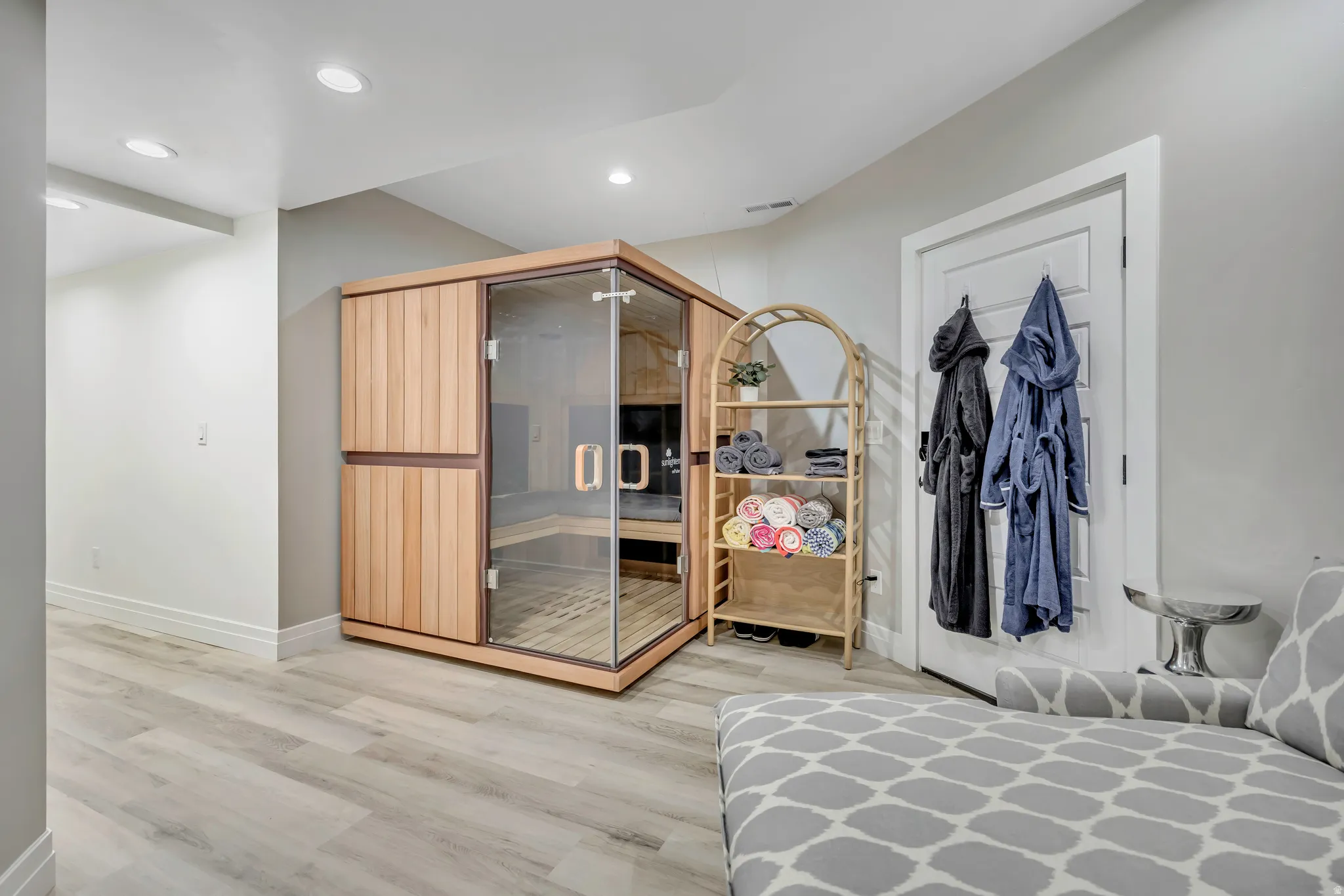 Bedroom featuring light wood-style flooring, recessed lighting, and a relaxing sauna