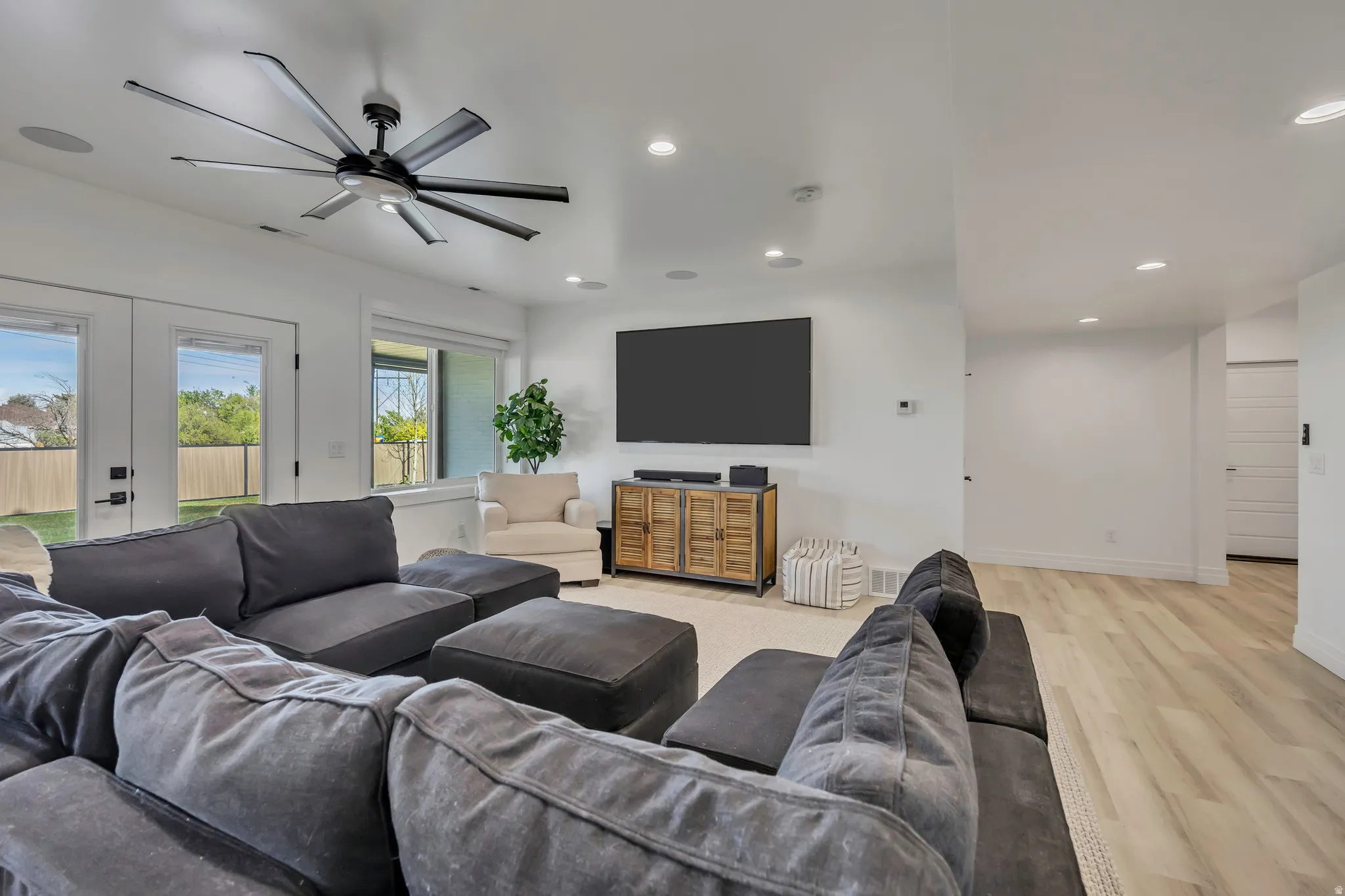Living area with light wood-style flooring, french doors, a ceiling fan, and recessed lighting