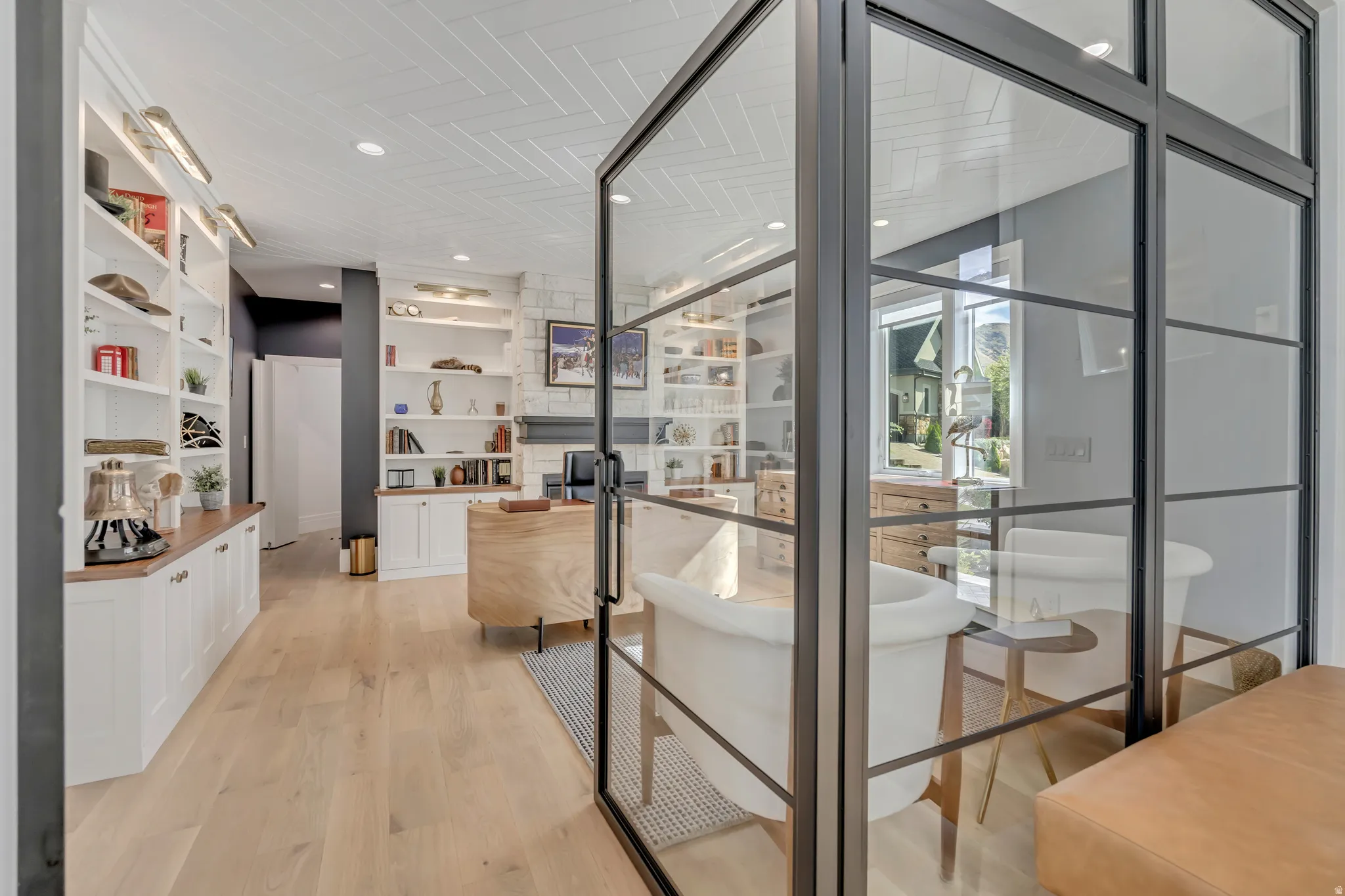 Wine cellar with light wood-type flooring and recessed lighting