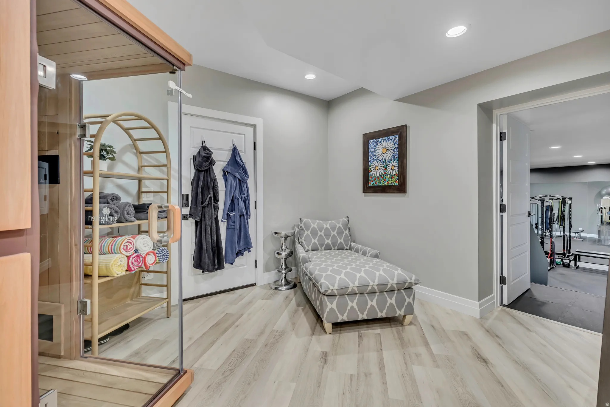Sitting room featuring a relaxing sauna, recessed lighting, and light wood-style flooring