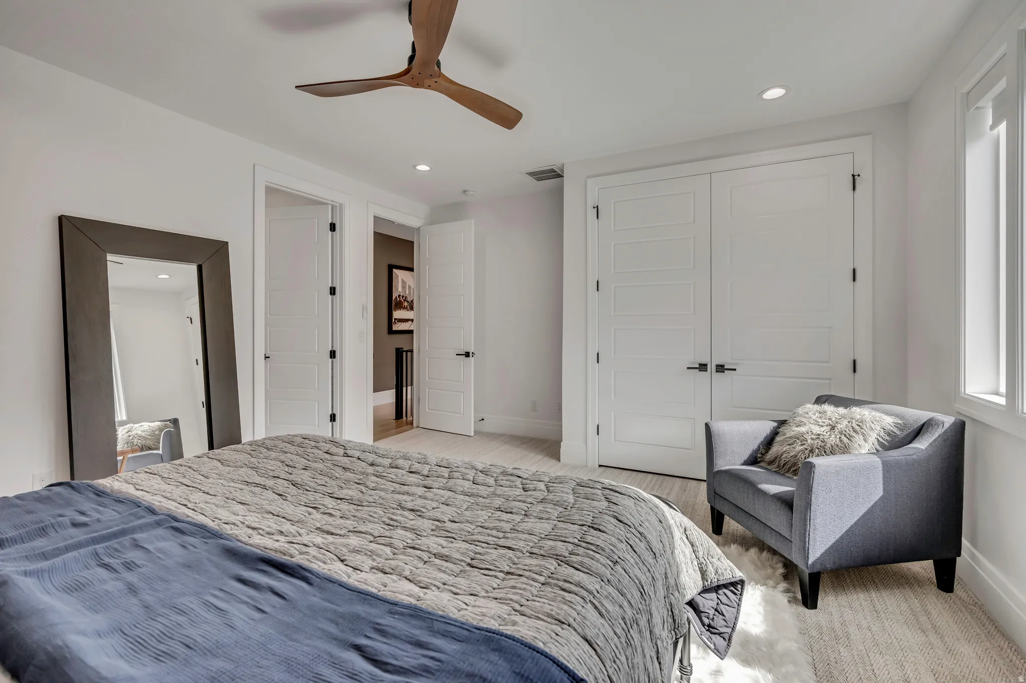 Bedroom with a closet, recessed lighting, and a ceiling fan
