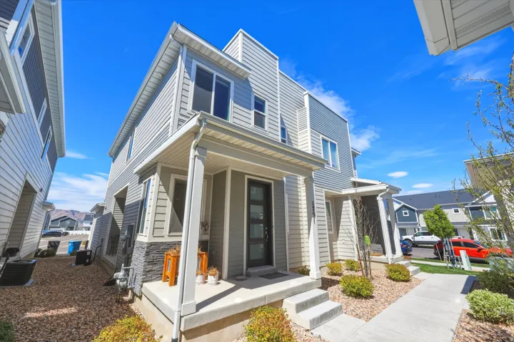 Modern home with stone siding and a residential view