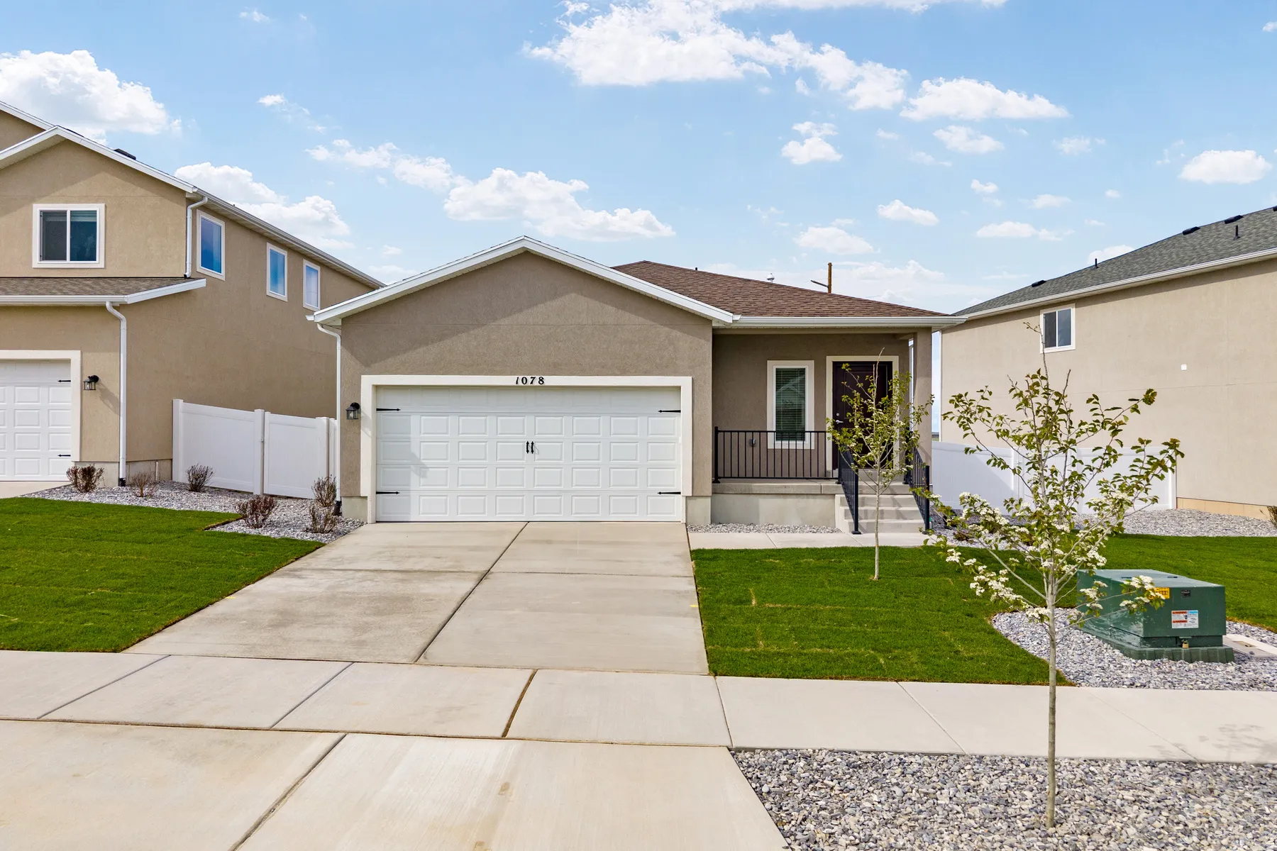 Single-story residence featuring a stucco exterior and a two-car garage with a panel door
