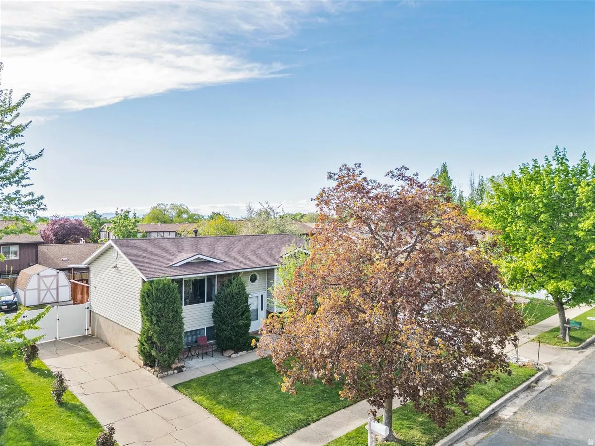 View of front facade with a front yard and a storage unit