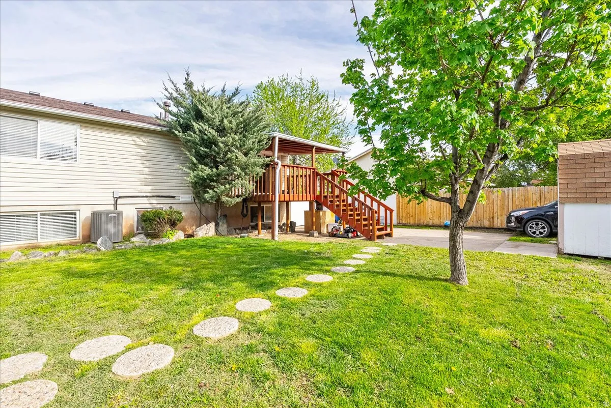 View of yard with stairway and a wooden deck