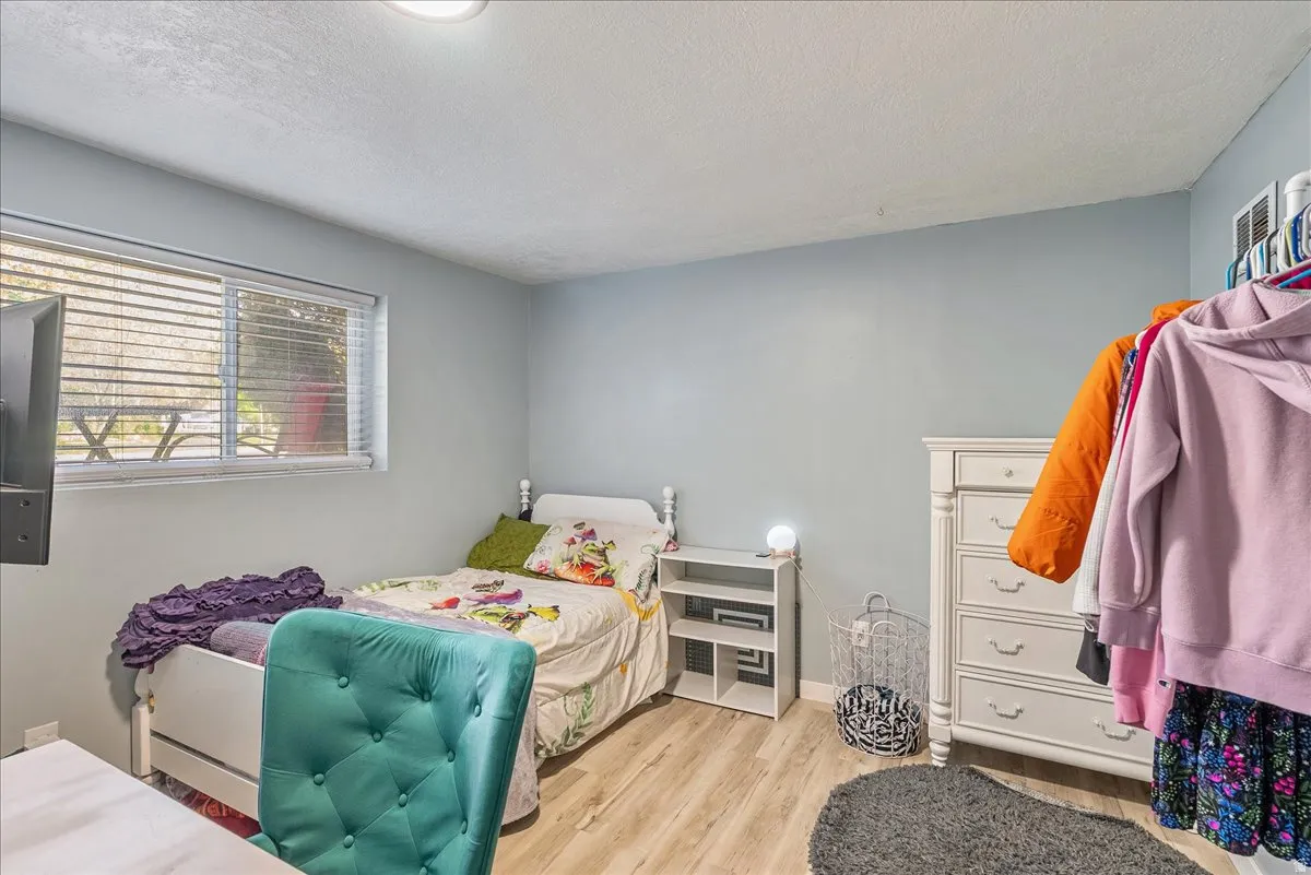 Bedroom featuring light wood finished floors and a textured ceiling