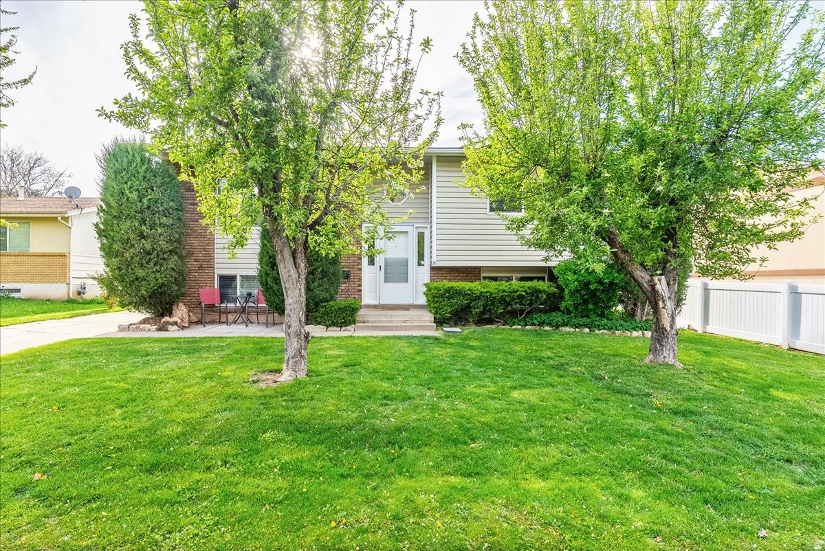 View of front of home with a patio and brick siding
