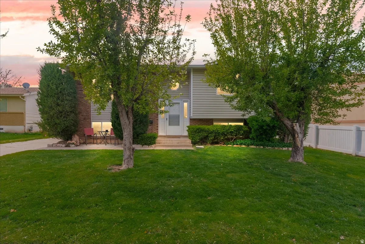 View of front of house featuring a patio area and brick siding