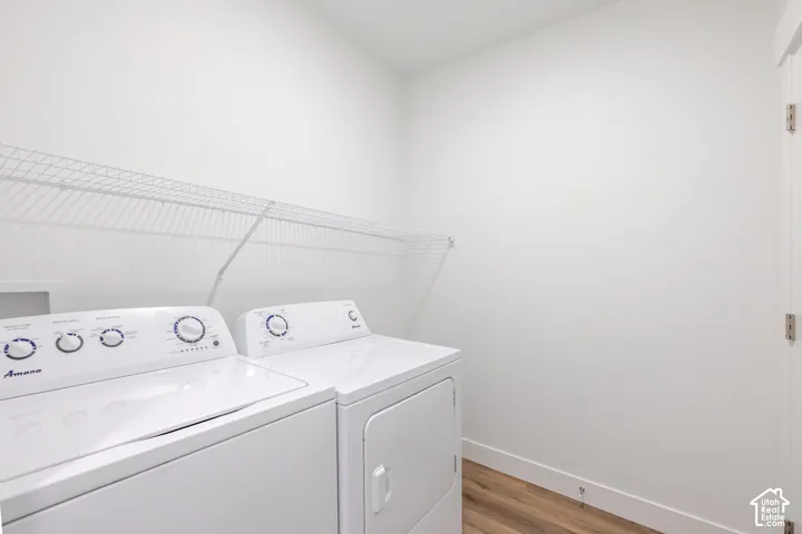 White walls, wood-finish flooring, and white wire shelving
