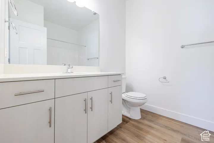 Vanity with a light-toned countertop, integrated sink, and brushed nickel faucet