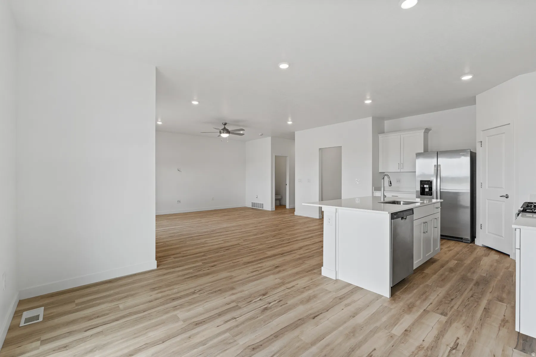 Open-concept living area featuring wood-finish flooring throughout