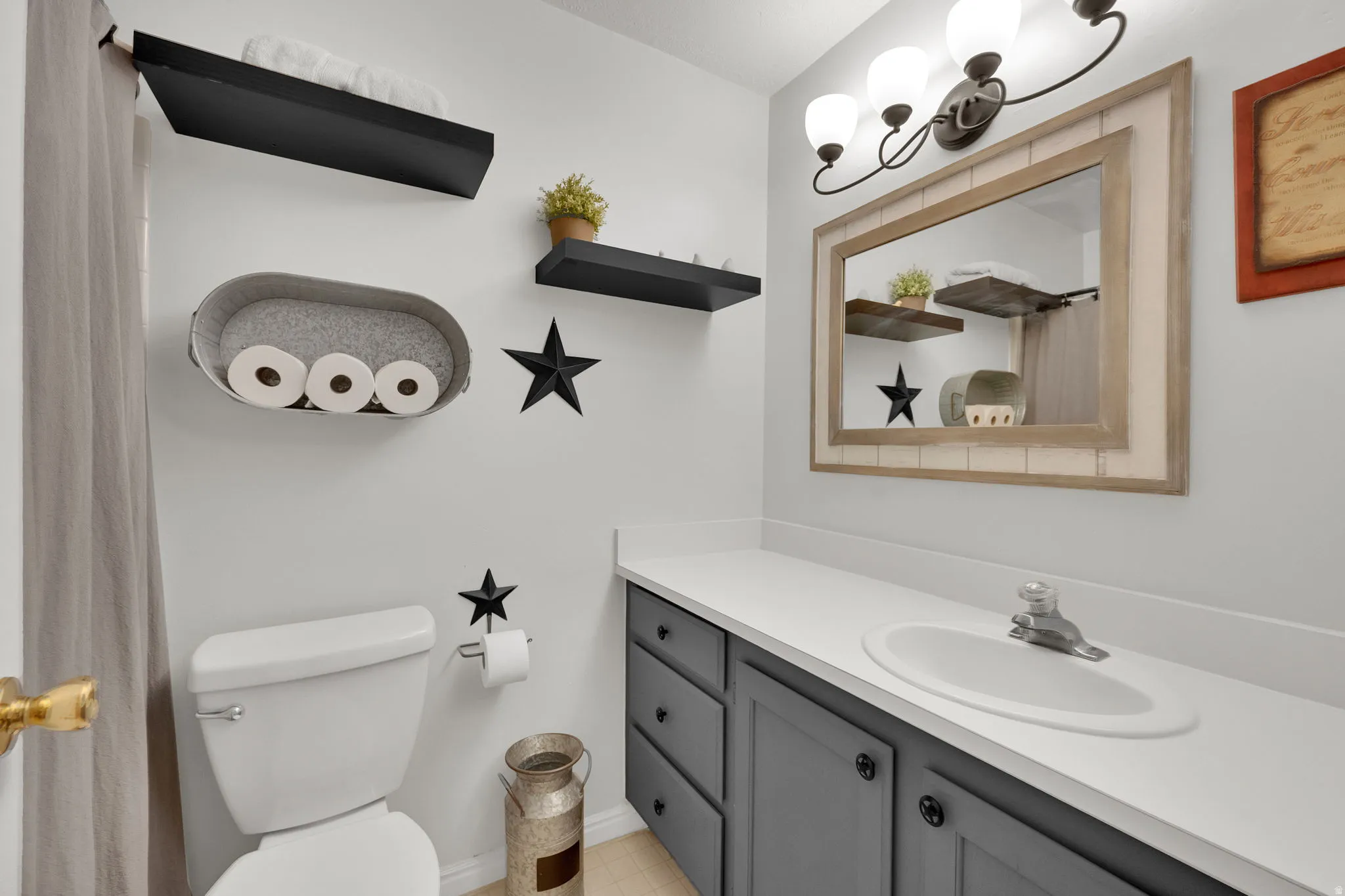 Bathroom featuring a shower with curtain and vanity