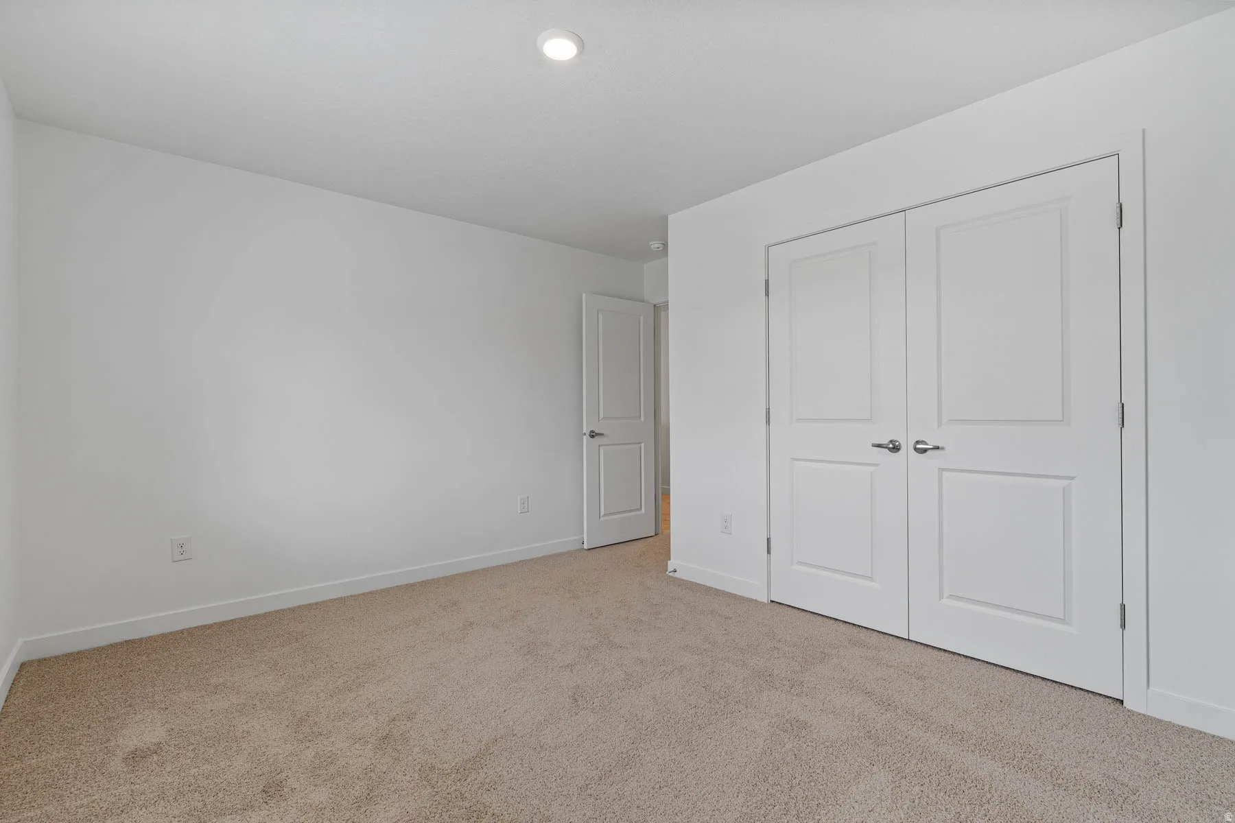 Neutral-toned carpeting paired with bright white walls