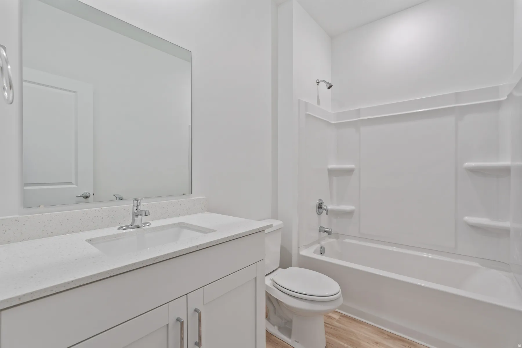 Bathroom featuring a white vanity with a light-toned countertop, an integrated sink, and a chrome faucet