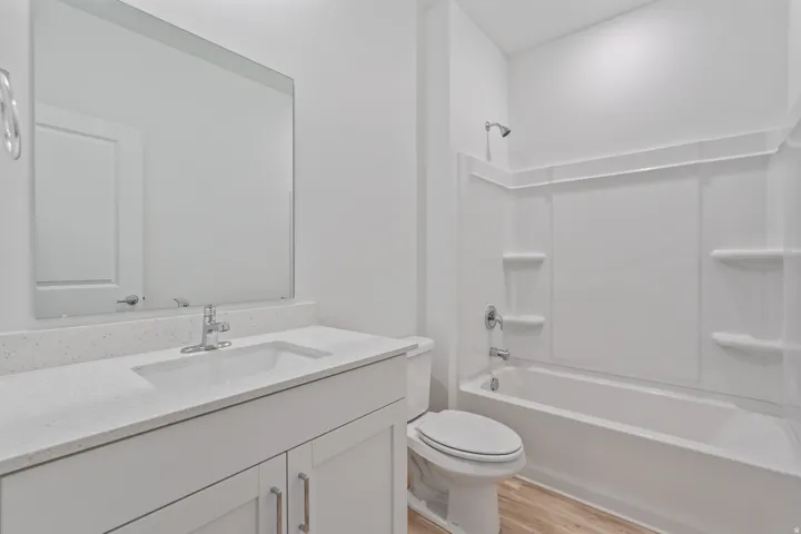 Bathroom featuring a white vanity with a light-toned countertop, an integrated sink, and a chrome faucet