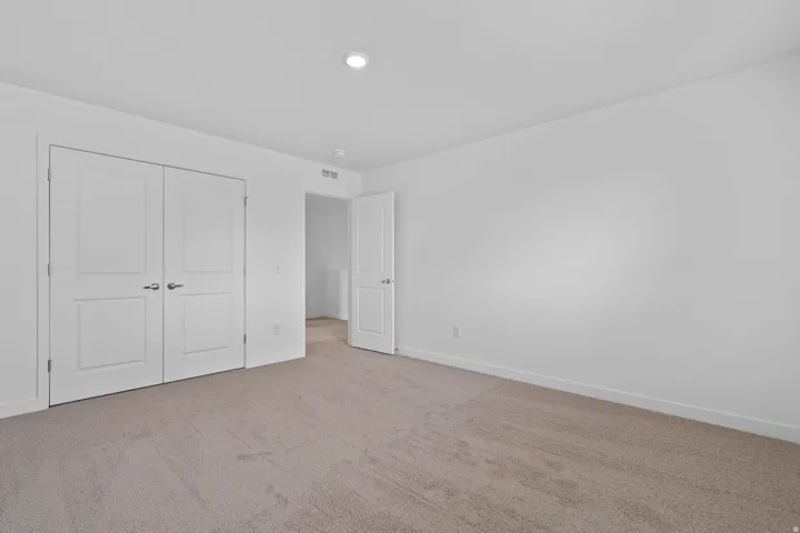 Carpeted room with a recessed ceiling light