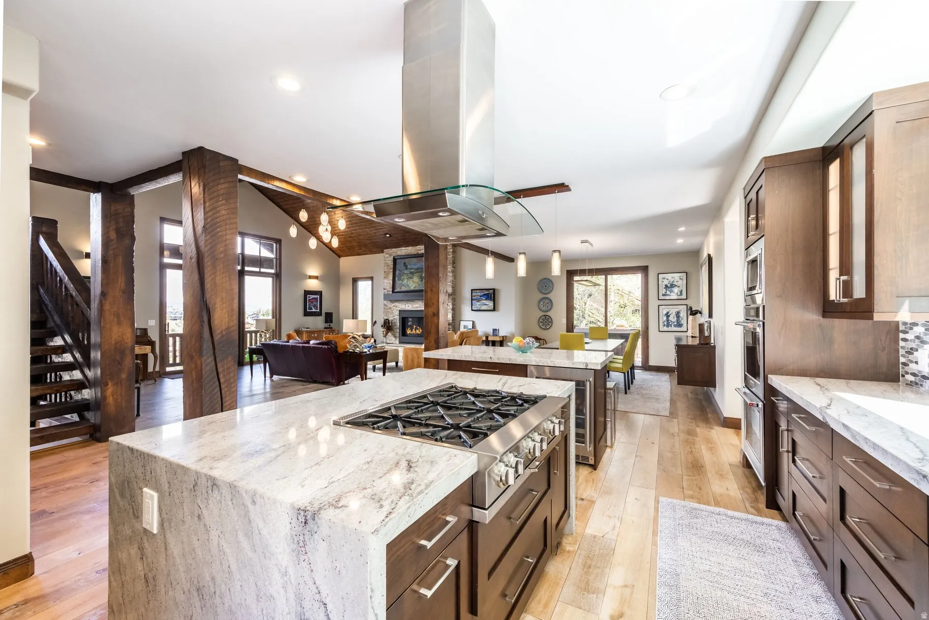 Gourmet kitchen with stainless steel range, double wall ovens, and a contemporary range hood